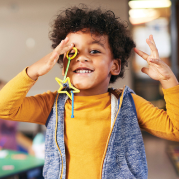 child playing with shapes toys