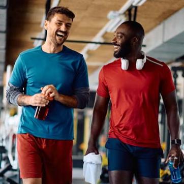 Friends walk and laugh in the free weight center