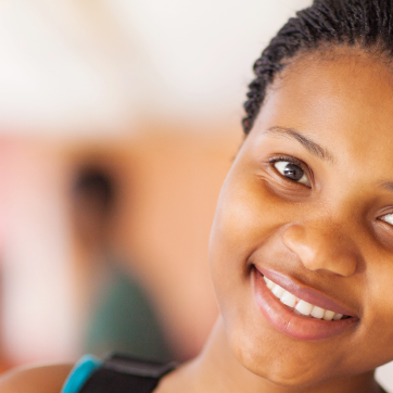 Woman smiling to the camera with background blurred