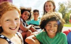Color fades with children smiling for Healthy Kids Day 2023