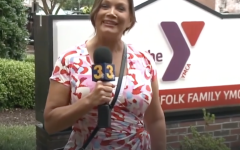 News reporter in front of the Blocker Norfolk Family YMCA