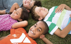 YMCA camp kids laying in the grass