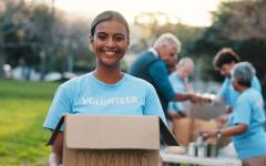 Volunteer holding a box outside