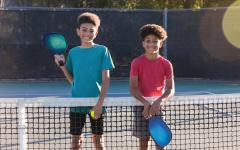 Teens on the outdoor pickleball court