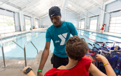 YMCA teen staff in the aquatics center by the pool