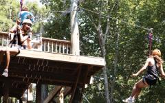 kids at summer camp doing tower climbling