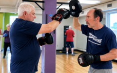Instructor and participant in Rock Steady Boxing program at blocker Norfolk YMCA