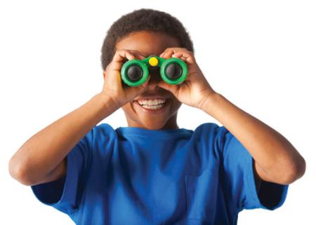 African-American boy smiling and looking at you through binoculars