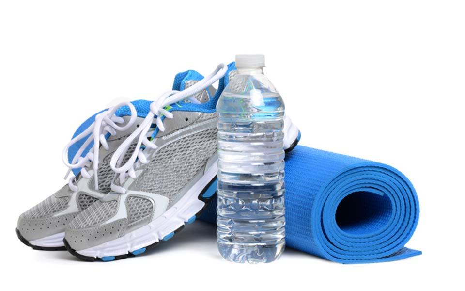 Sneakers, bottle of water and yoga mat