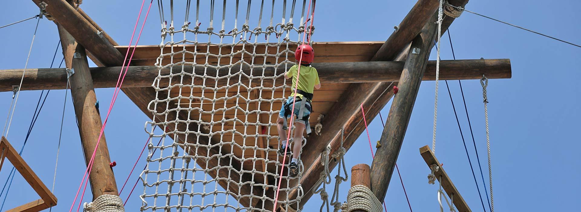 child scaling the alpine tower