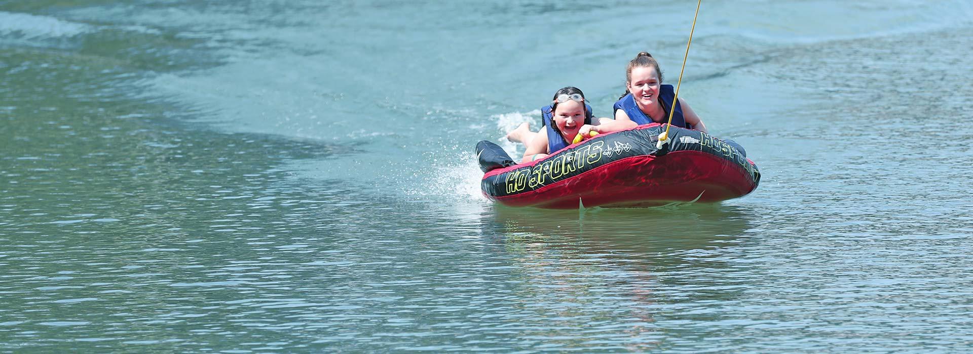 children on inner tube on the water