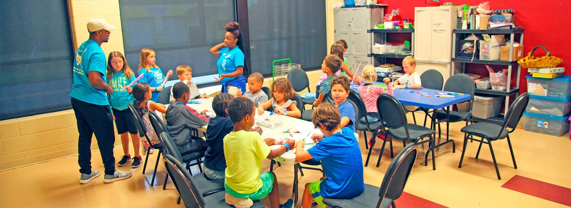 Summer campers creating art in the Arts Studio at the YMCA on Granby