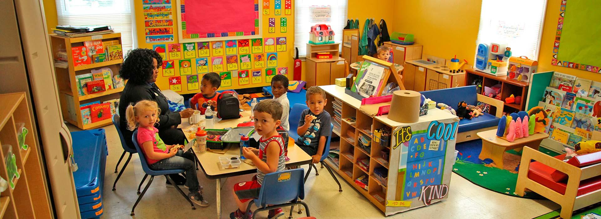 Preschoolers at table activity in preschool classroom at Salem YMCA Family Center