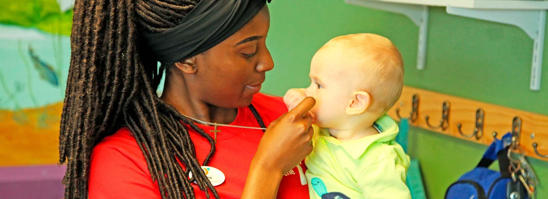 Taylor Bend Family YMCA child care employee caring for child