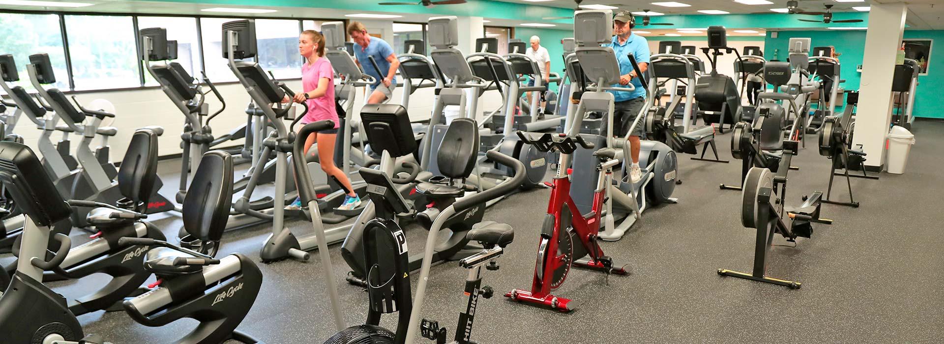 Members using cardio equipment, including treadmills, ellipticals, bikes and steppers at the Portsmouth YMCA