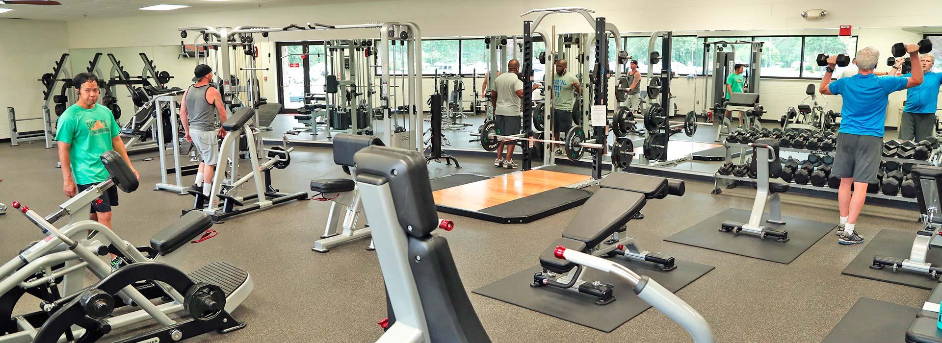 Members lifting weights in the free weight center at the Portsmouth YMCA