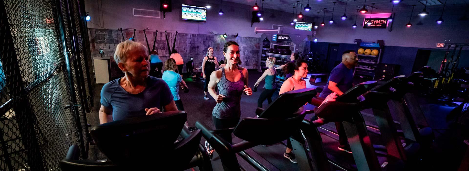 People running on treadmills in REGYMEN fitness workout
