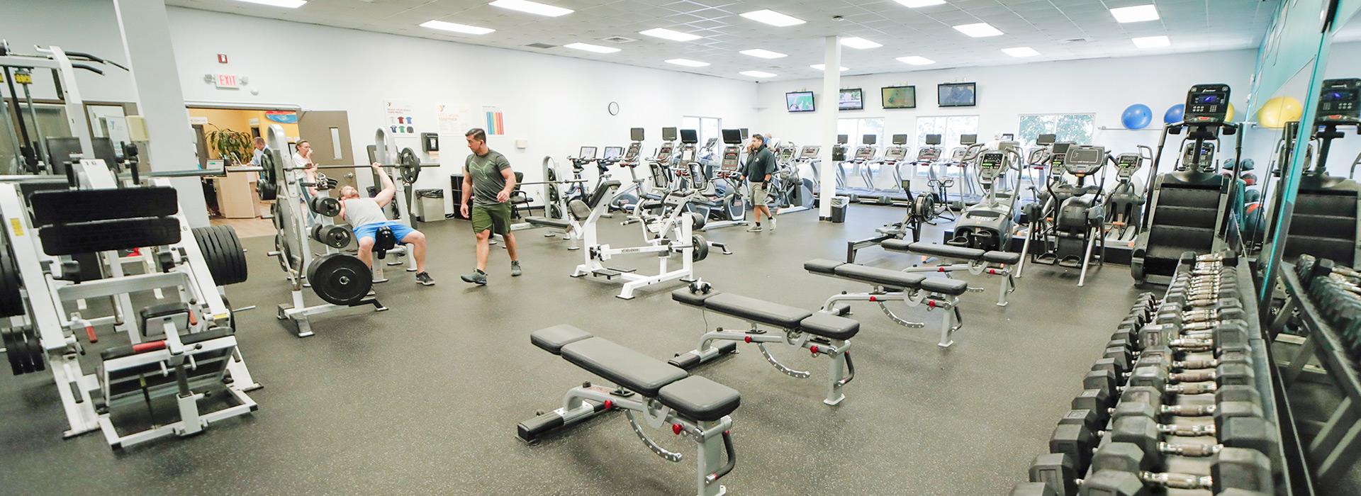 Members working out in the free weight area of the wellness center at the Hilltop Family YMCA