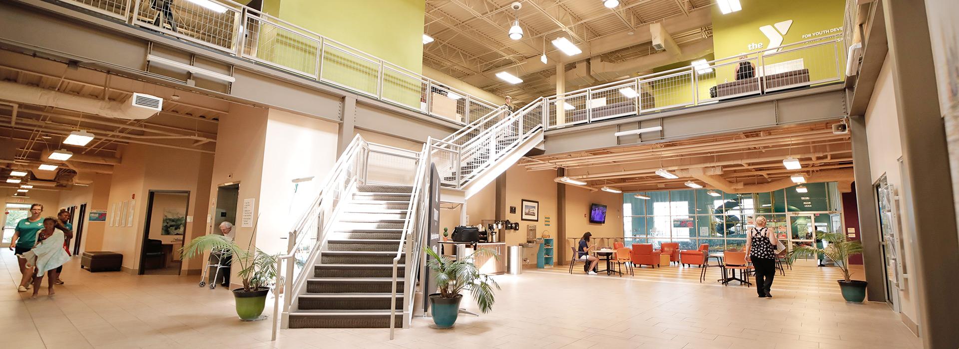 Princess Anne Family YMCA lobby, looking upstairs to wellness center and down the hall to the left to Stay & Play and to the right to the indoor pool and splash park.