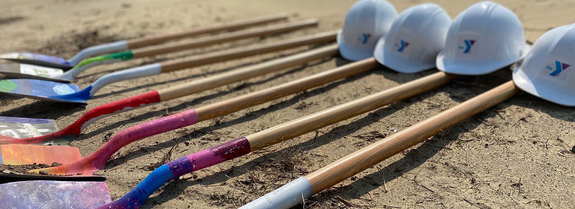 Painted shovels decorated by YMCA campers and YMCA hardhats at the groundbreaking ceremony for the Northampton County YMCA