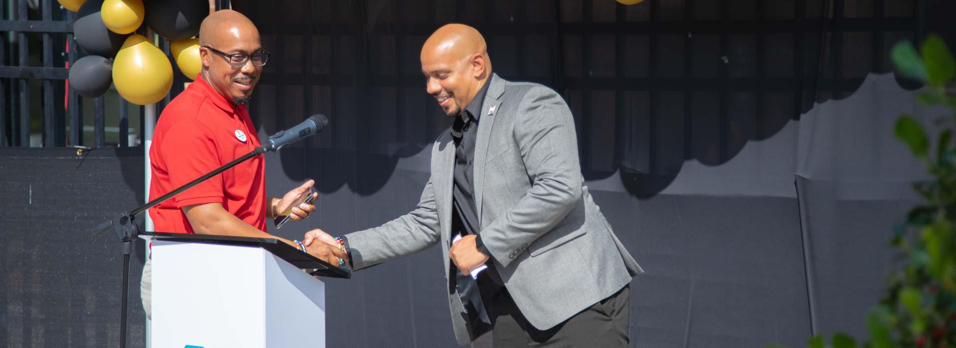 President & CEO, and first executive director of the YMCA on Granby Anthony Walters shakes current executive director Dr. Joe Rampersad's hand during the YMCA on Granby's 10th Anniversary Celebration