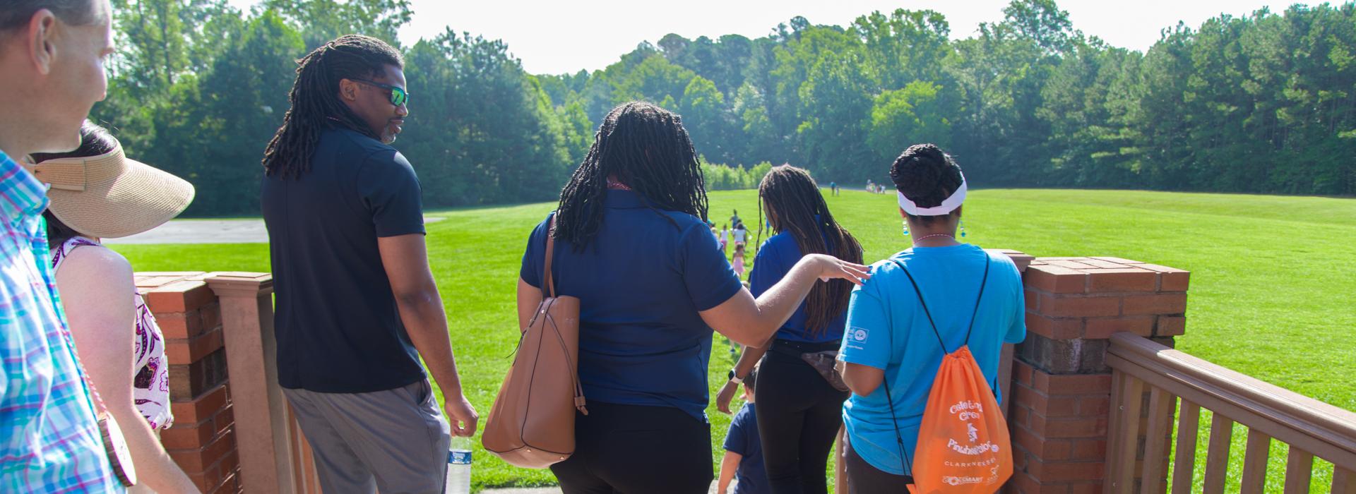 Camp donors look out across YMCA Camp Red Feather's fields