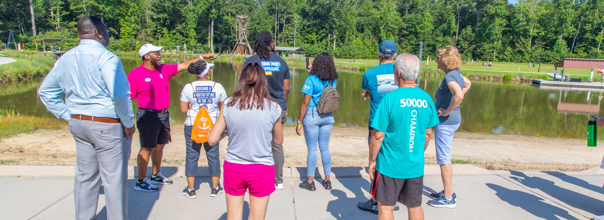 YMCA staff points out features of YMCA at JT's Camp Grom to YMCA donors