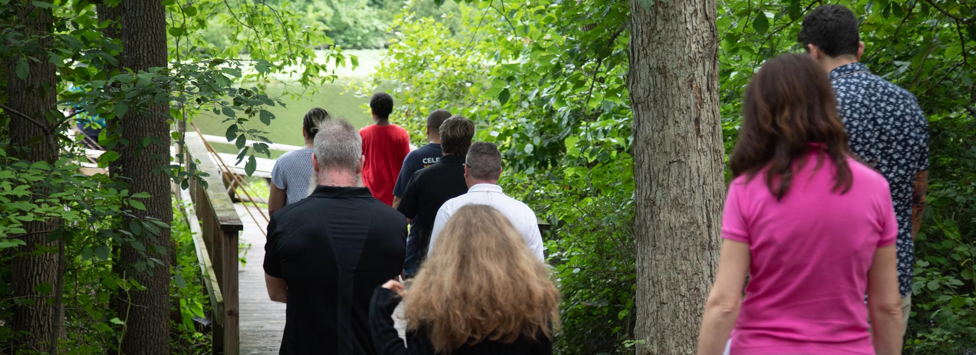 Camp donors walk along the fishing pier at YMCA Camp Red Feather