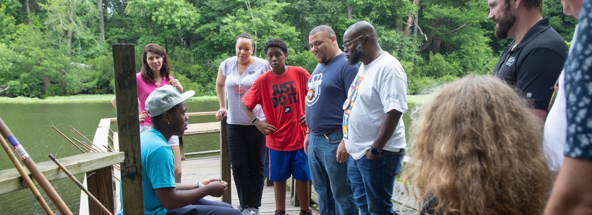 Camp donors gather on the fishing pier at YMCA Camp Red Feather