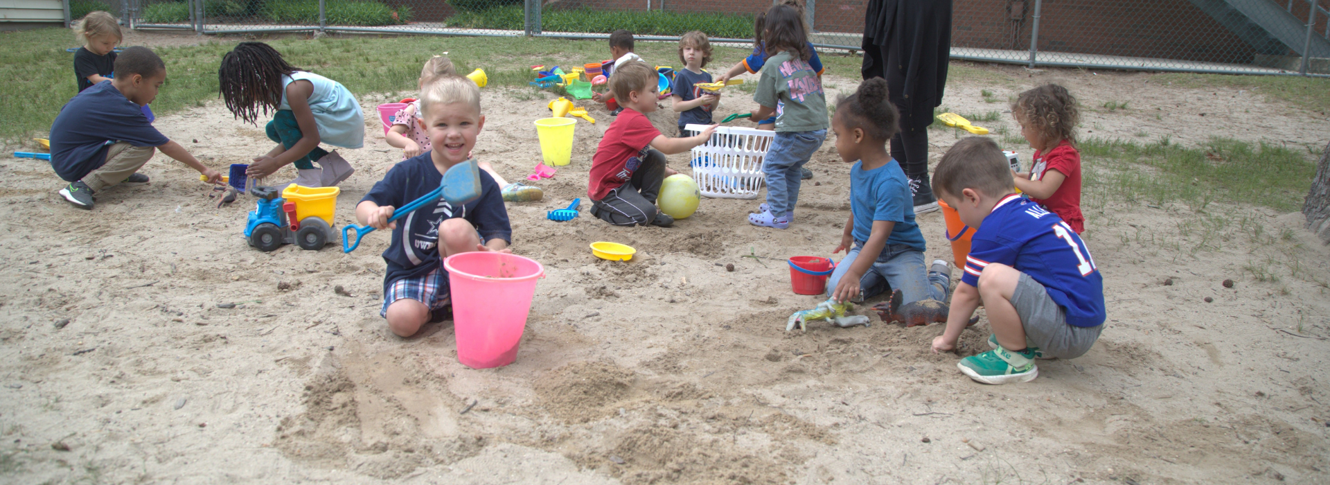 Kids playing in a sandbox at the Mt. Trashmore Family YMCA preschool