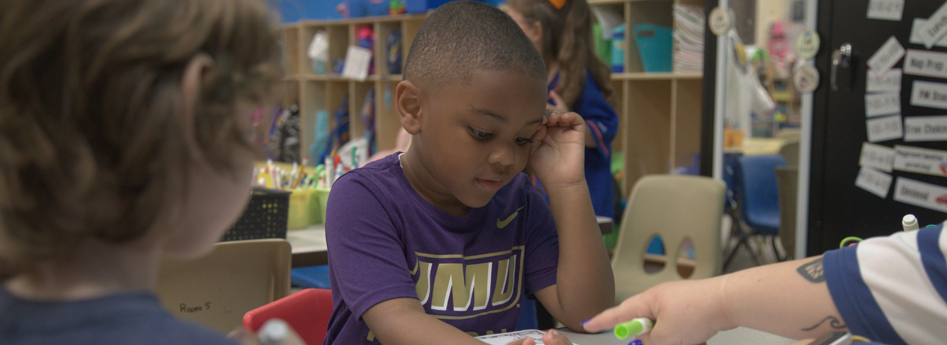 Kid doing coursework in a classroom at the Mt. Trashmore Family YMCA preschool