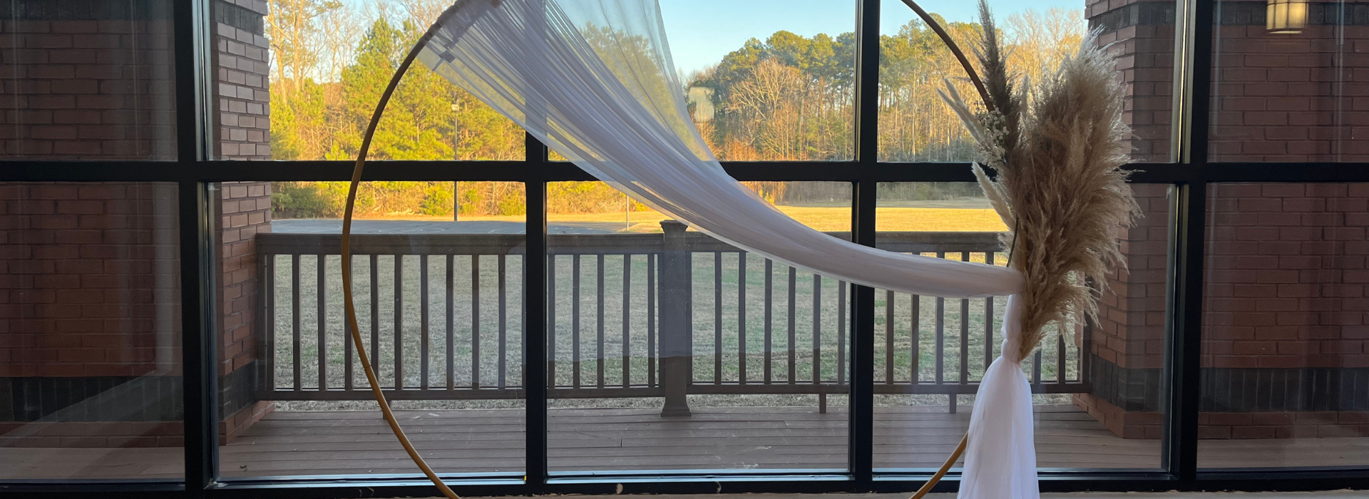 wedding archway with a gold hoop and feathers
