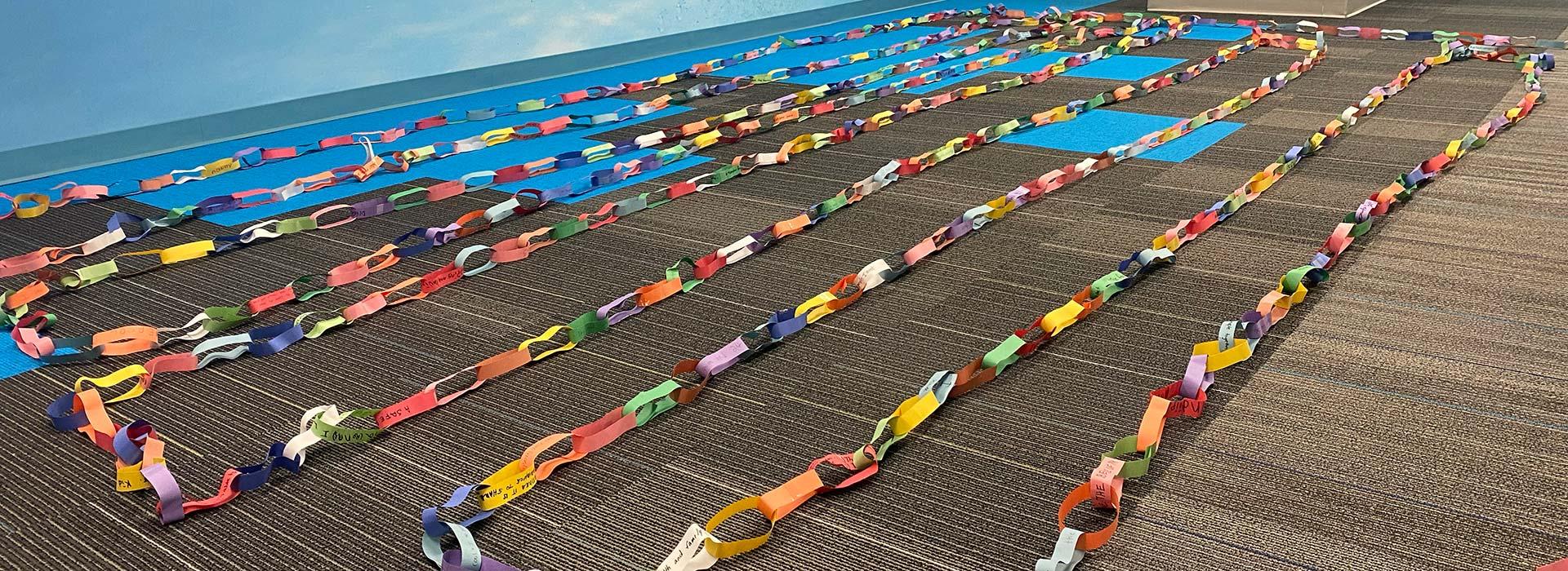 Strips from YMCA kids and attendees to the prayer breakfast linked together as a community chain of connection