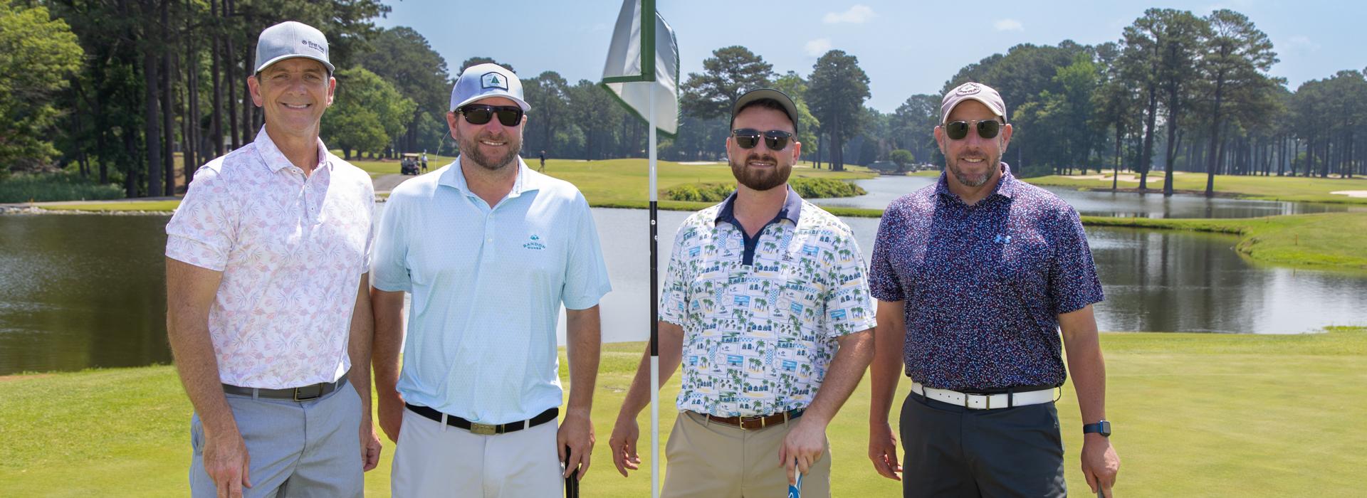 4-man golf team outside on a golf course at the YMCA Charity Golf Classic 2025