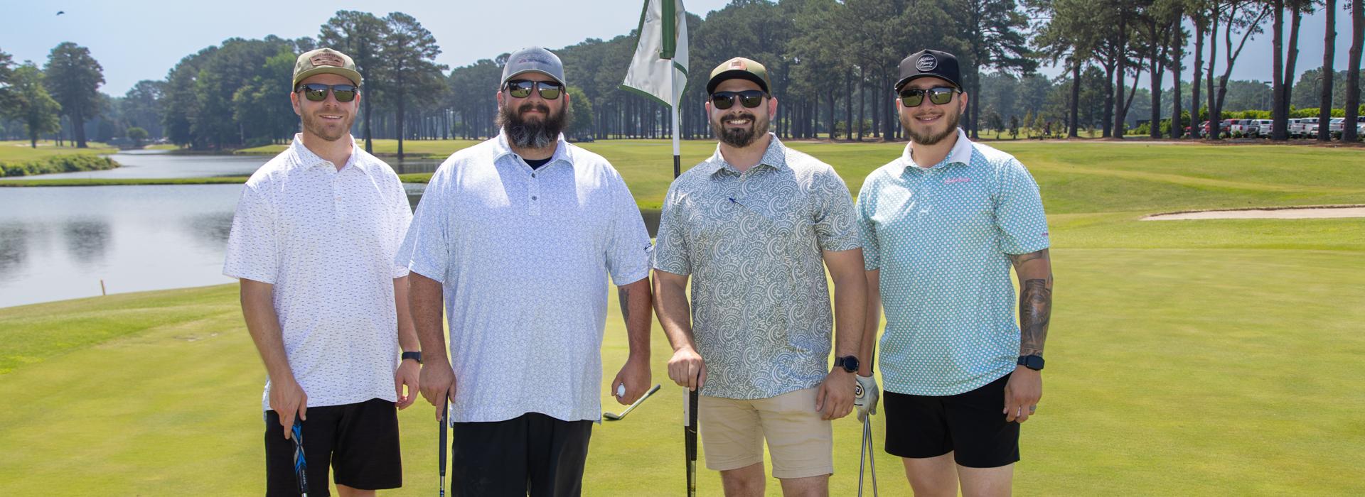 4-man golf team outside on a golf course at the YMCA Charity Golf Classic 2025