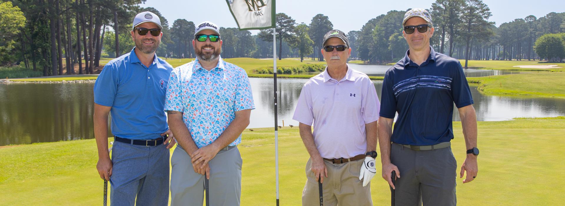 4-man golf team outside on a golf course at the YMCA Charity Golf Classic 2025