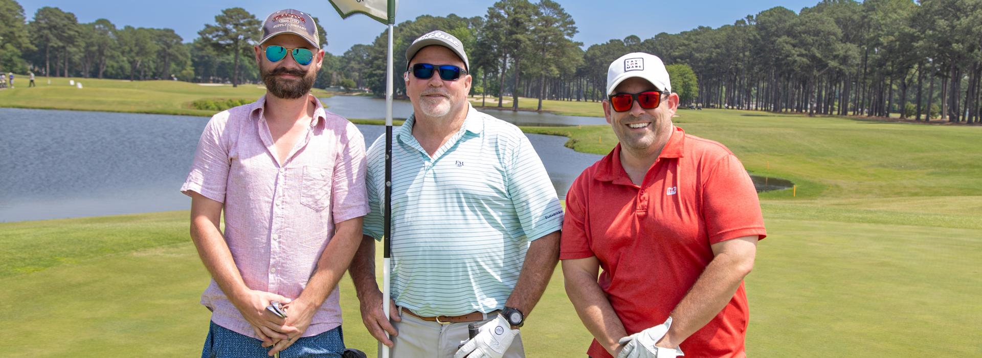 3-man golf team outside on a golf course at the YMCA Charity Golf Classic 2025