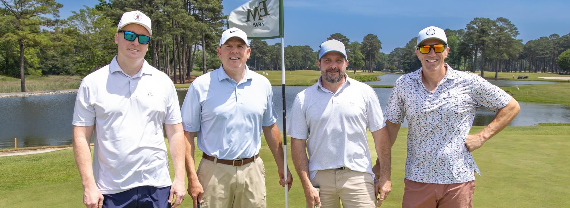 4-man golf team outside on a golf course at the YMCA Charity Golf Classic 2025
