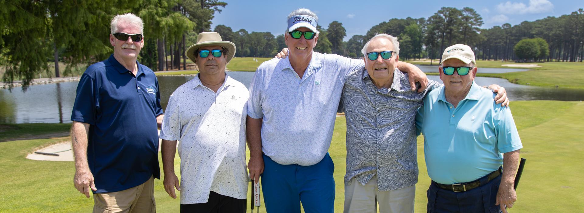 5-man golf team outside on a golf course at the YMCA Charity Golf Classic 2025