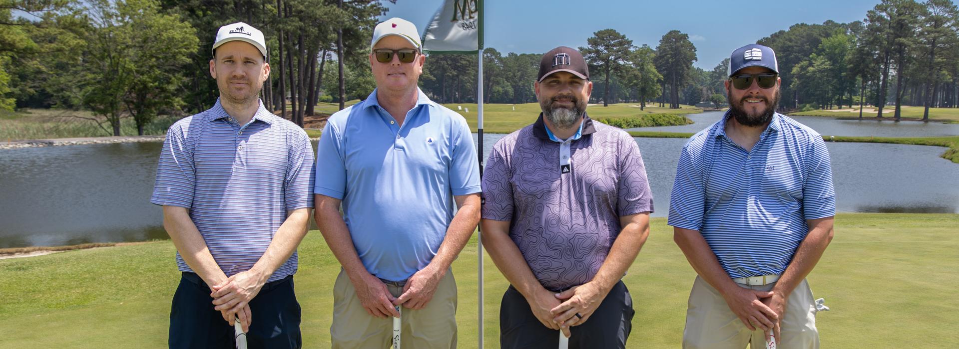 4-man golf team outside on a golf course at the YMCA Charity Golf Classic 2025