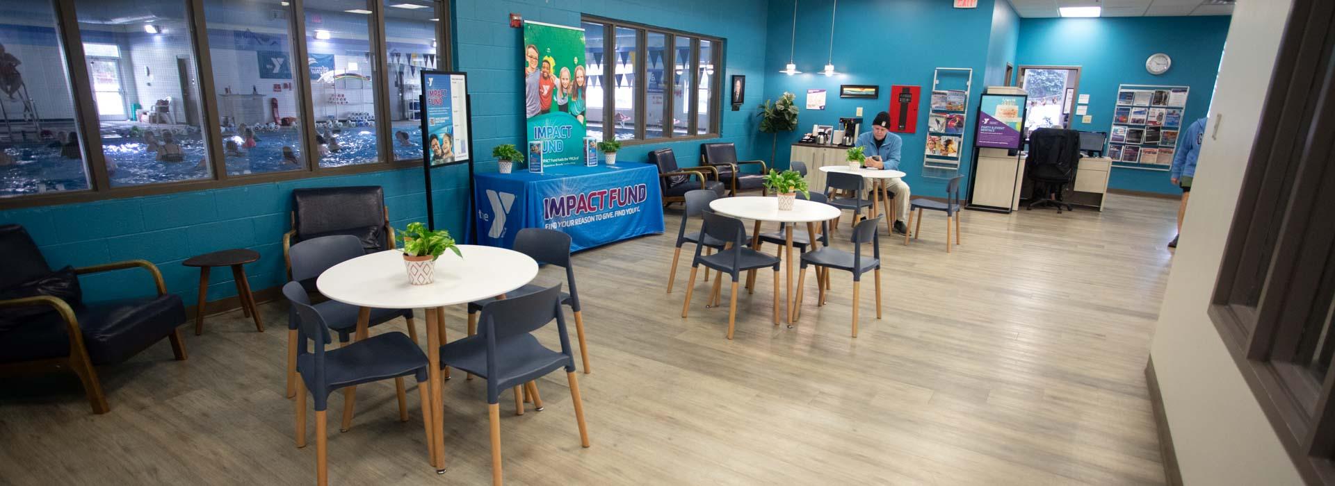Lobby area with lounge chairs and tables at the Outer Banks Family YMCA