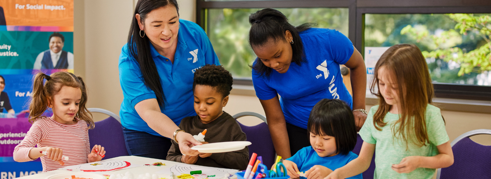 Diverse group of kids and staff doing afterschool activities at the YMCA