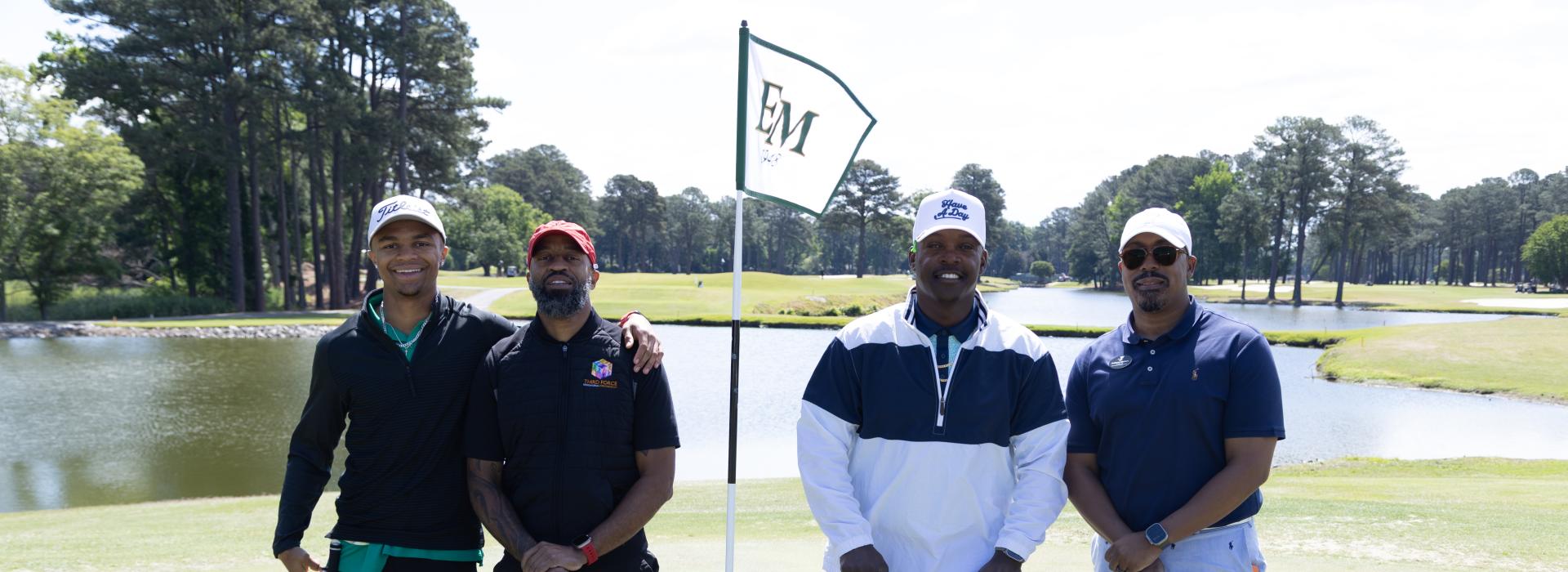 4 men on a golf course
