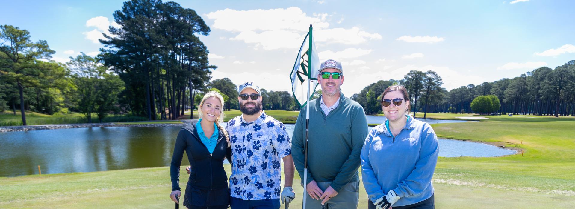 2 men and 2 women on the golf course