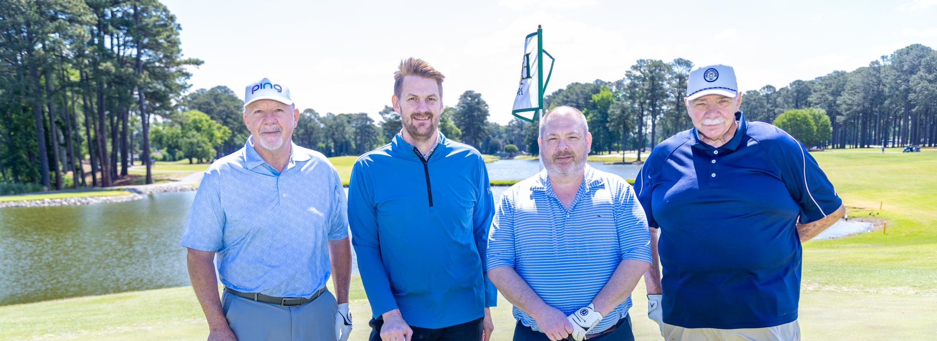 4 men on the golf green