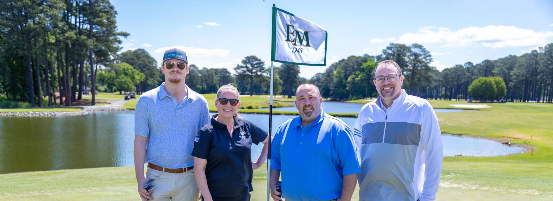3 men and 1 woman on the golf course