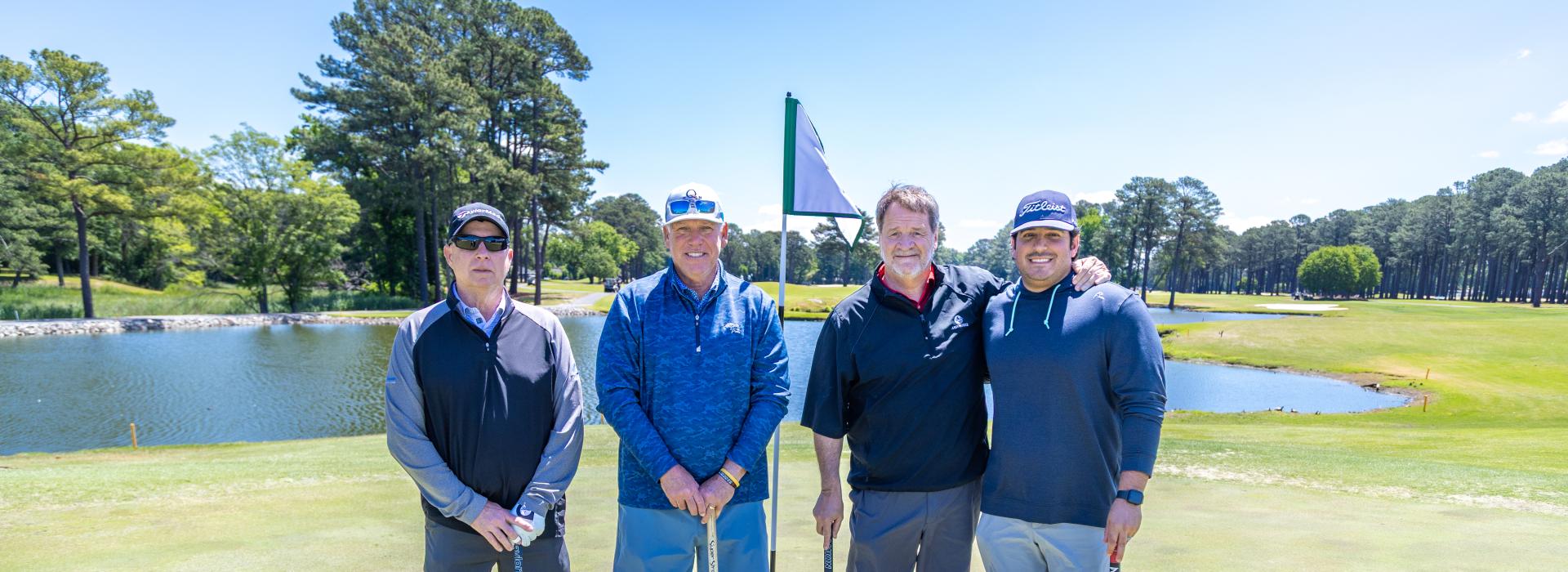 4 men on the golf green