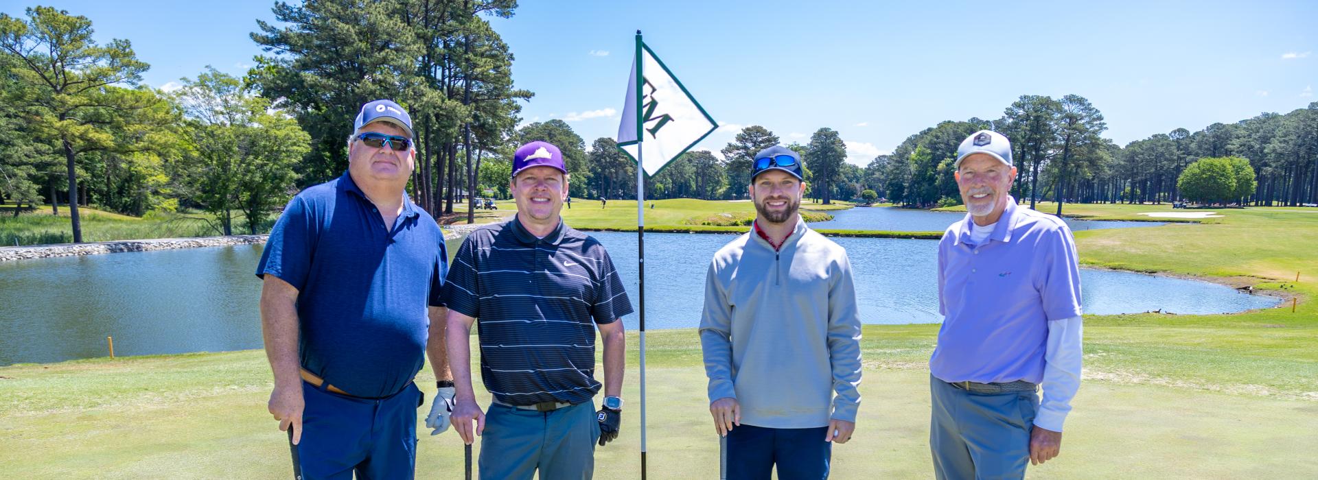 4 men on the golf green