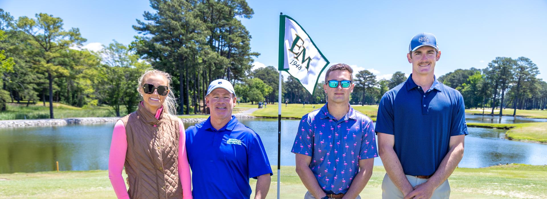 3 men and 1 woman on the golf course