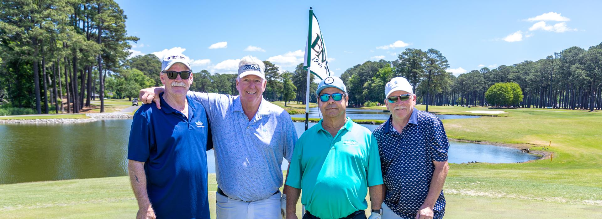 4 men on the golf green
